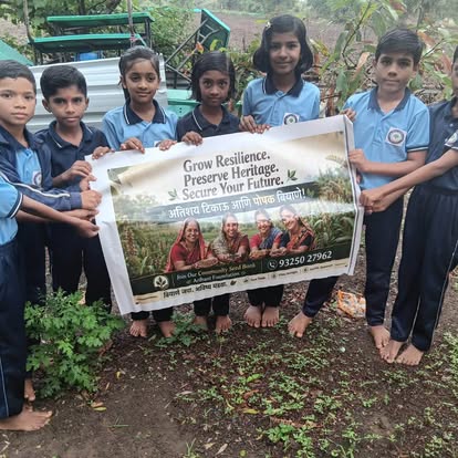 Schoolchildren at Badakwasti School holding the Community Seed Bank banner