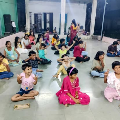 Children gathered on the floor for an evening learning circle