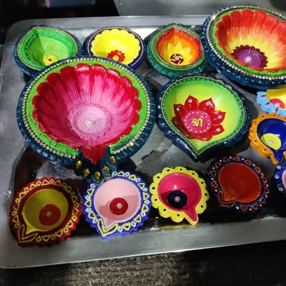 Hand-painted Diwali diyas on a tray