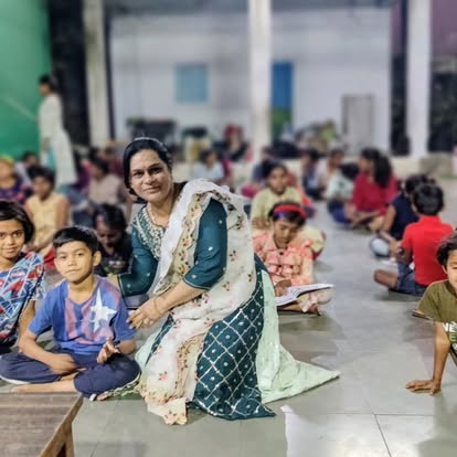 Community assembly with children seated together